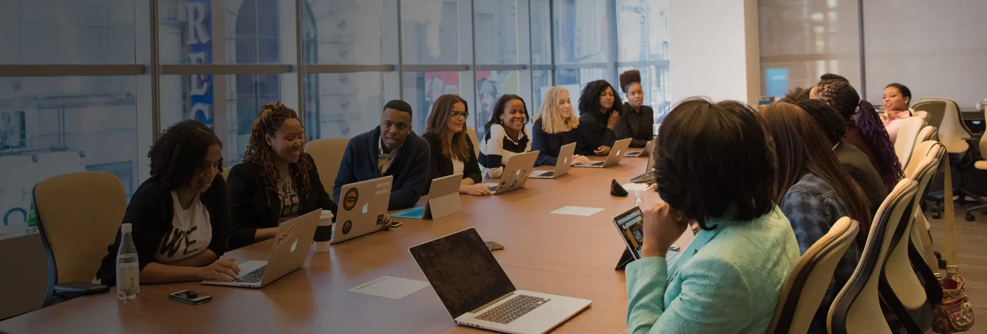 Colleagues around a boardroom table during a business meeting