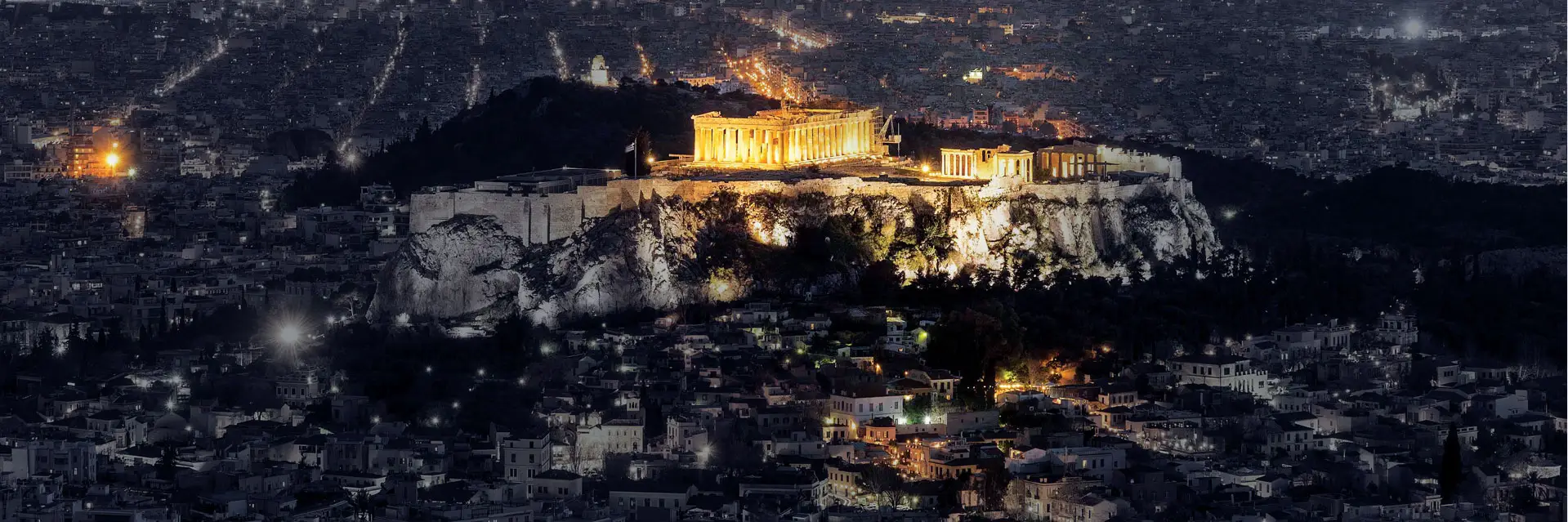 The Acropolis lit up above Athens at night