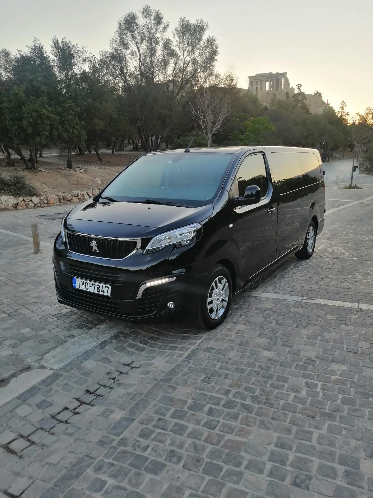 Mini van Peugeot Traveller κάτω από την Ακρόπολη στο ηλιοβασίλεμα
